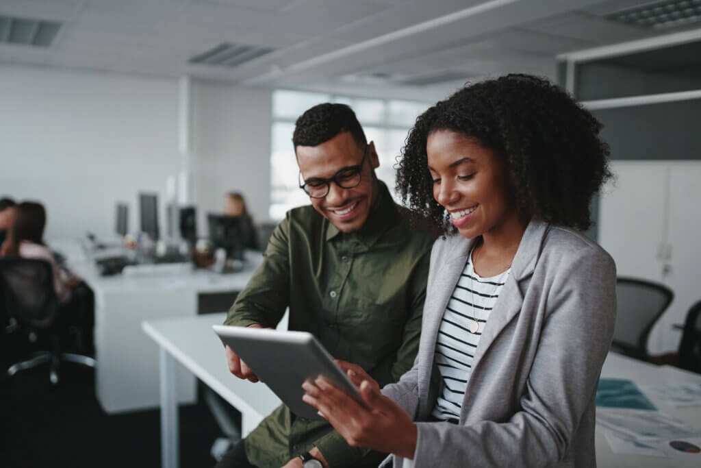 an african american man and woman collaborating on a tablet