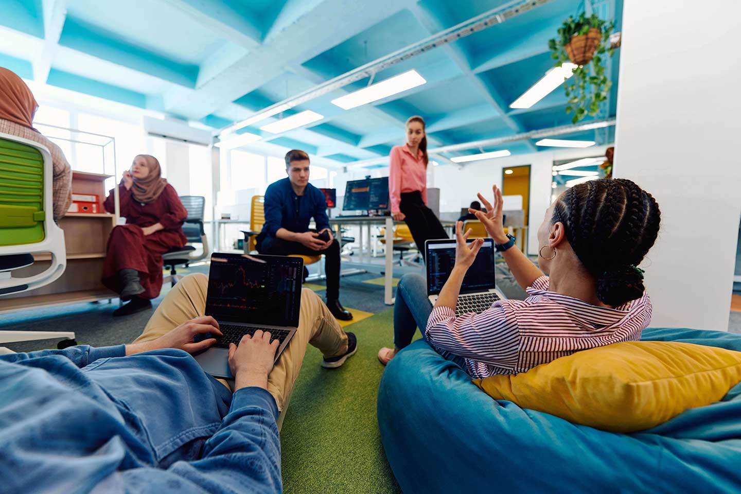 Group of young coworkers collaborating in bean bags