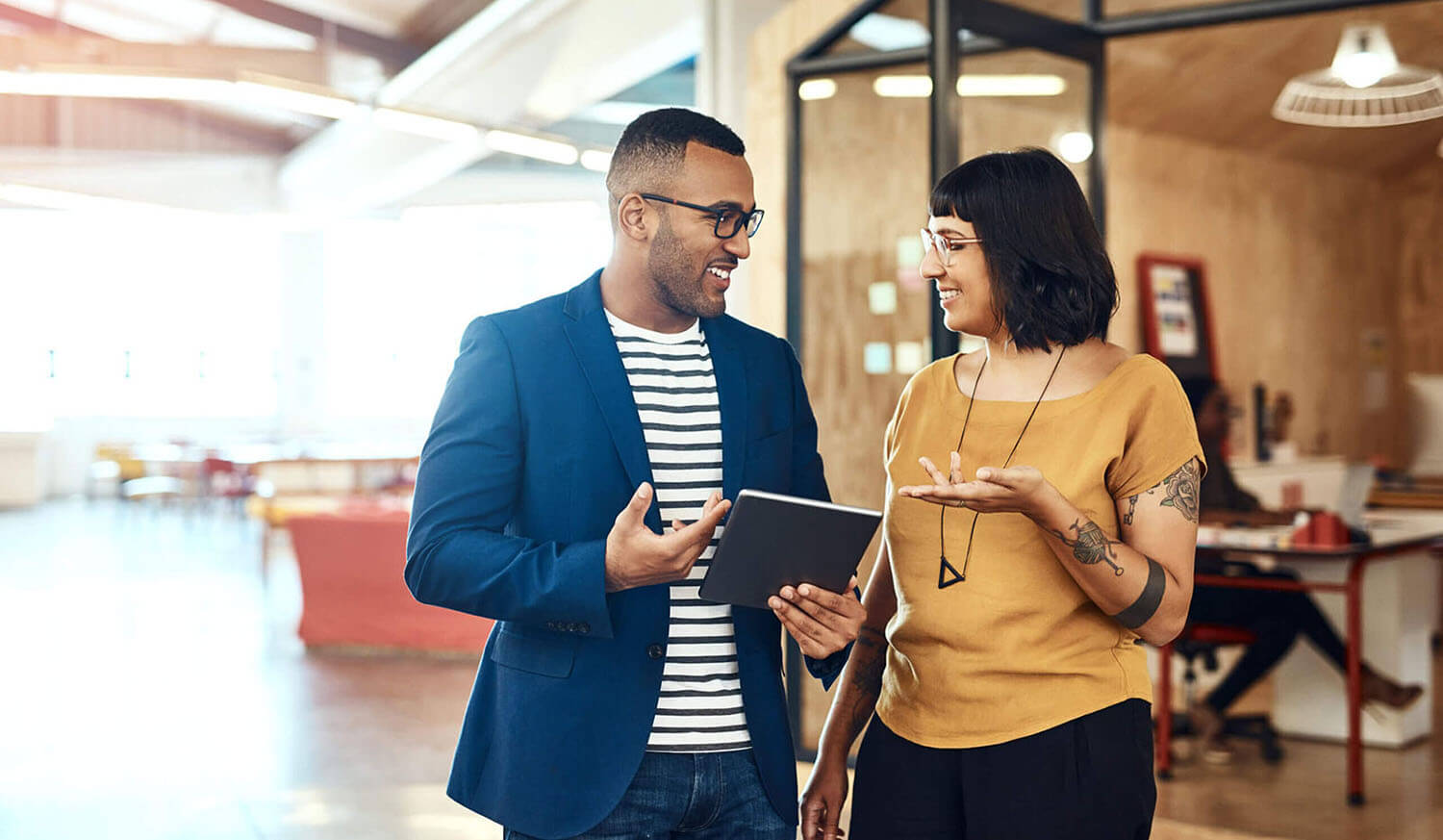 Business people, tablet and a team talking in office with ideas, internet and online motivation. A professional man and woman together for a creative startup project with app for discussion or advice