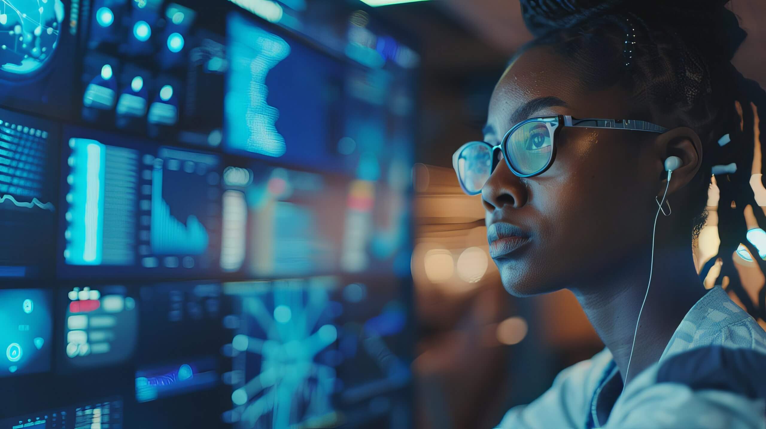 African American woman looking at data systems wall