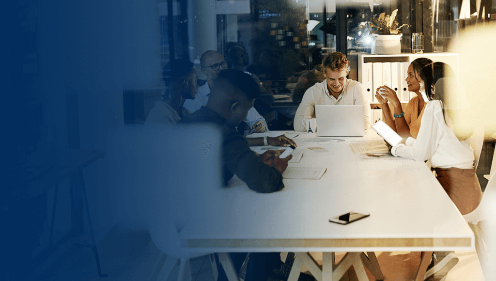 team of coworkers in a modern office meeting at a table