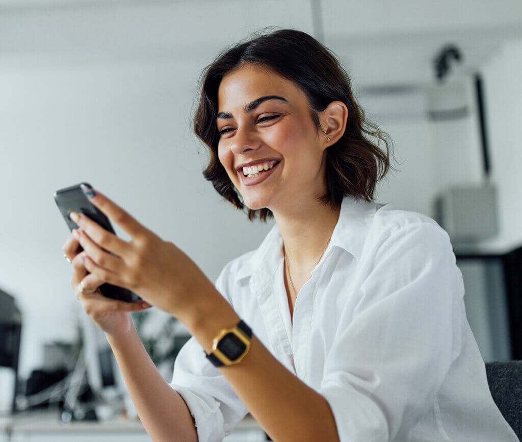 Smiling woman consulting her smartphone