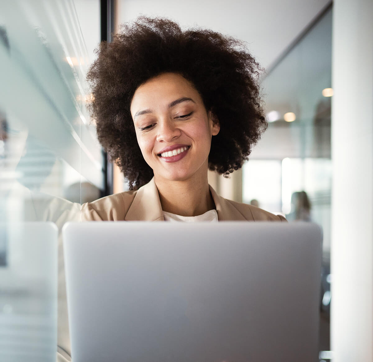 Smiling woman consulting a laptop computer