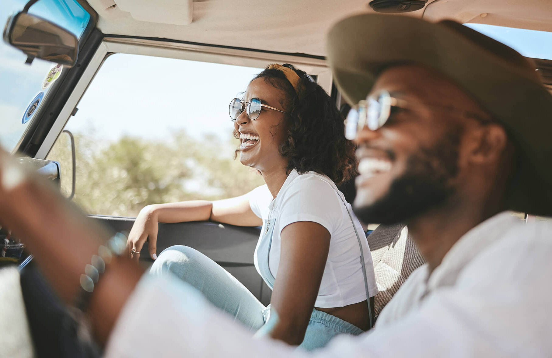 Travel, road trip and black people couple driving by countryside for holiday, journey and freedom with happiness. Trendy sunglasses, fashion and gen z friends in a car drive for vacation lifestyle.