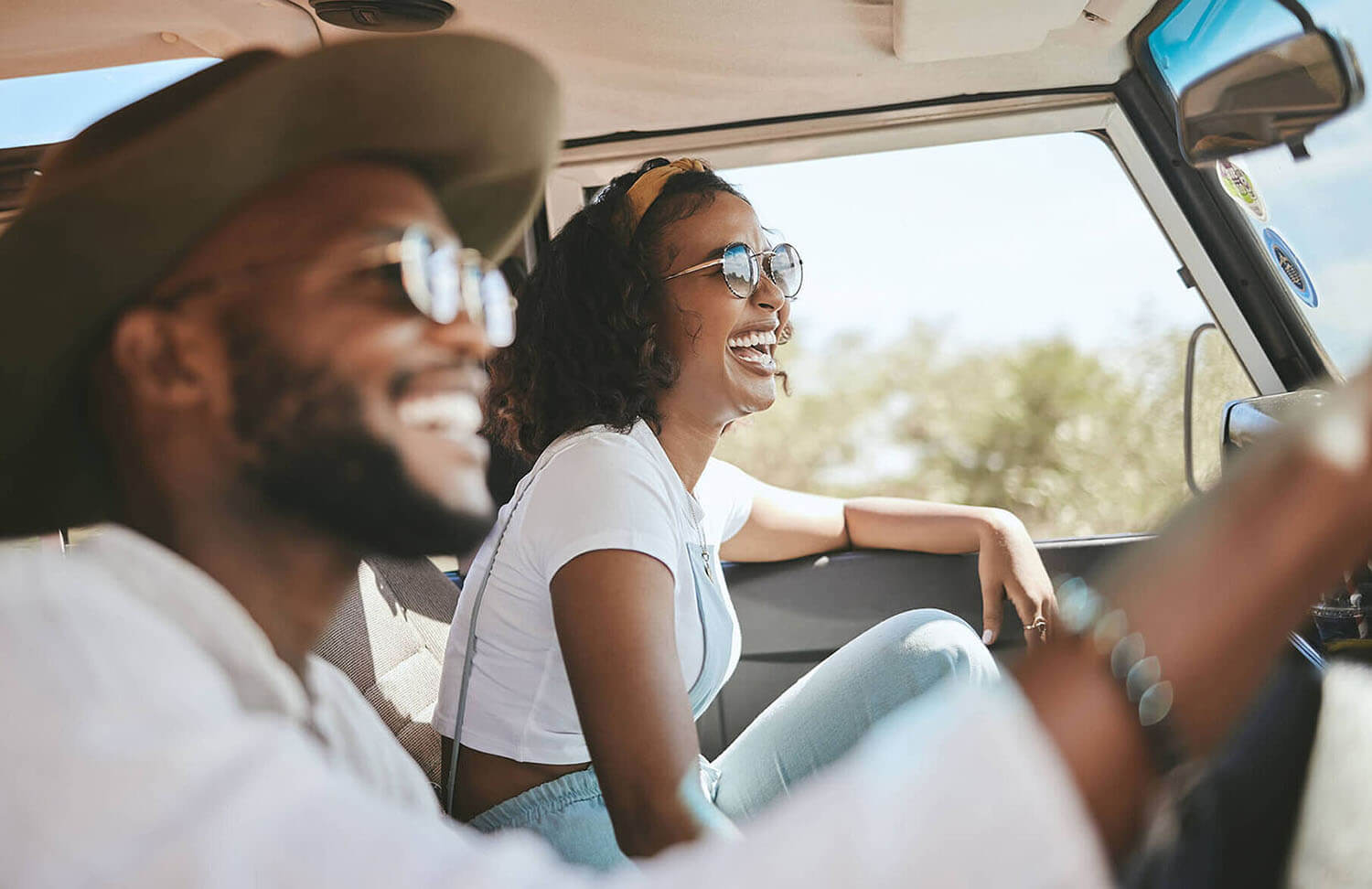 Travel, road trip and black people couple driving by countryside for holiday, journey and freedom with happiness. Trendy sunglasses, fashion and gen z friends in a car drive for vacation lifestyle.