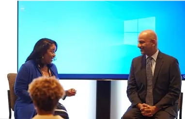 Two panelists talking at a presentation.