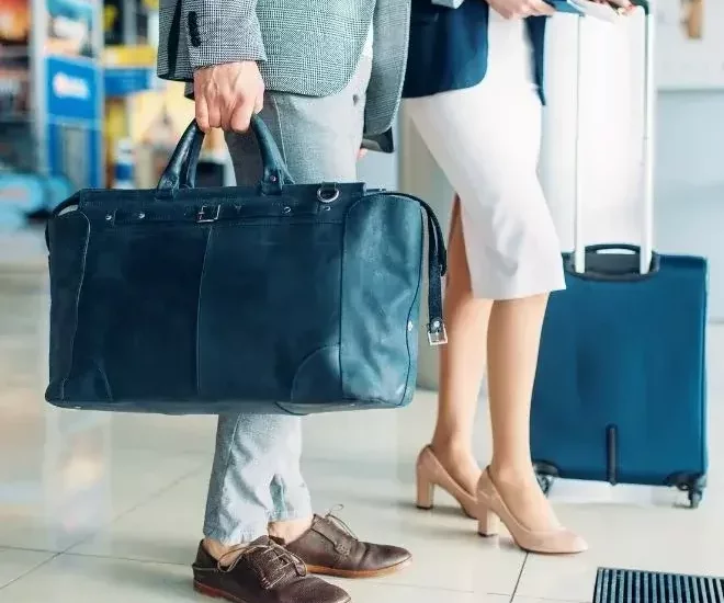 man and woman with luggage at airport-jpg