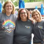 Three people attending the pride event.